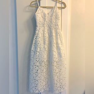 White appliqué midi dress. Adjustable straps. Zipper back closure.